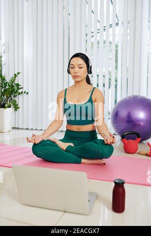 Woman meditating at home Stock Photo