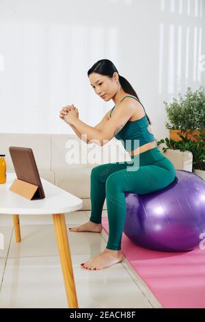 Woman doing fitball squats Stock Photo