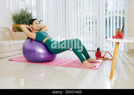 Fit woman doing abs exercise Stock Photo