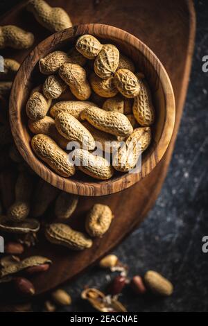 Roasted peanuts. Tasty groundnuts in a bowl. Top view. Stock Photo