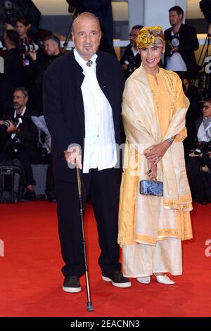 File photo - Jean-Claude Carriere and his wife attending the At Eternity's Gate Premiere as part of the 75th Venice International Film Festival (Mostra) in Venice, Italy on September 03, 2018. Jean-Claude Carrière, the prolific French screenwriter who collaborated with some of the greatest art house auteurs of his time, has died. He was 89. Carrière died Monday evening of natural causes at his home in Paris. Carrière won a competitive Oscar in 1963 for his work with countryman Pierre Étaix on a live-action short film, then received an honorary Academy Award at the Governors Awards in 2014. Pho Stock Photo