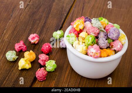 Sweet multicolor caramel Popcorn in white bowl. Studio Photo Stock Photo