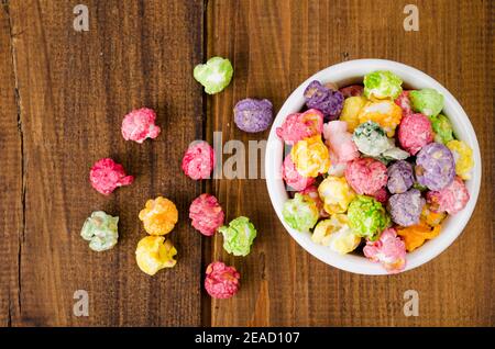 Sweet multicolor caramel Popcorn in white bowl. Studio Photo Stock Photo