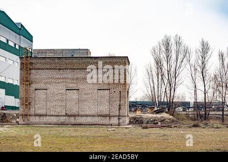 Brick building with three bricked-up window. production premise. Stock Photo