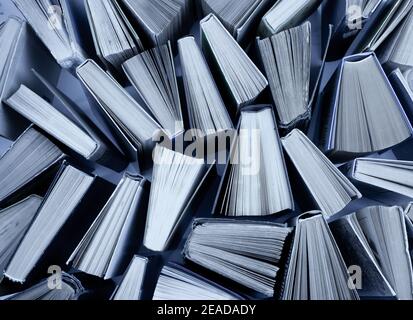 Book background. Old books in the library. Bookshelf shop. Knowledge publications, literature. Bookish bookstore, bookshop. White pages. Gray solid ba Stock Photo