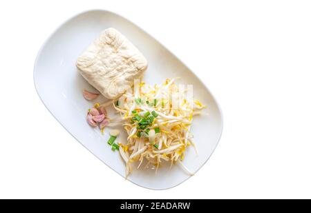 Top view Organic bean sprouts, tofu, garlic and scallions in white plate. Isolated 0rganic bean sprouts, tofu, garlic and scallions in white plate on Stock Photo