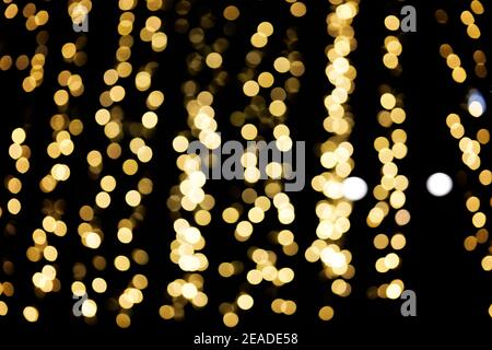 Defocused lights of christmas garlands, golden bokeh light Stock Photo