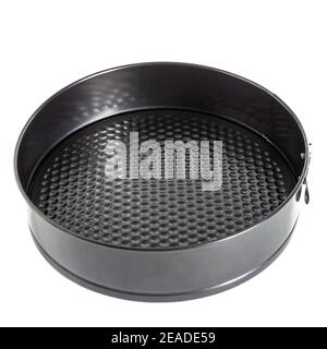 Round metal mold for baking cakes and pies. Black folding round insulated on white background. Close-up Stock Photo