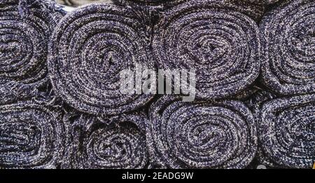 Close up on many stacking carpet rolls. Stock Photo