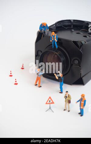 CCTV surveillance security camera with worker doing maintenance or installing. Stock Photo