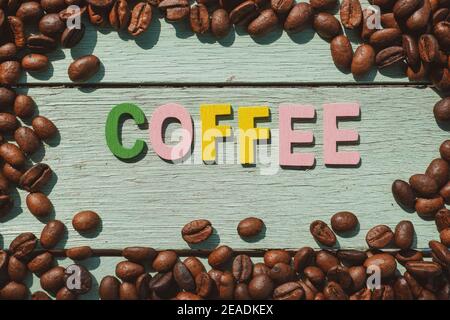 Coffee Day alphabets form on roasted coffee beans background. Stock Photo