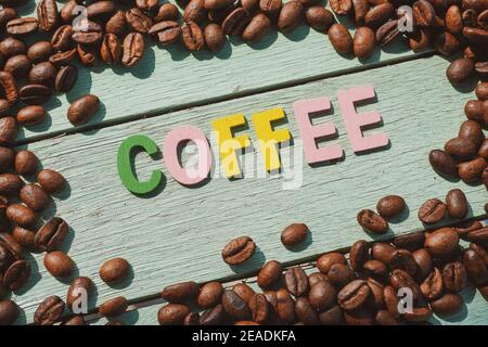 Coffee Day alphabets form on roasted coffee beans background. Stock Photo