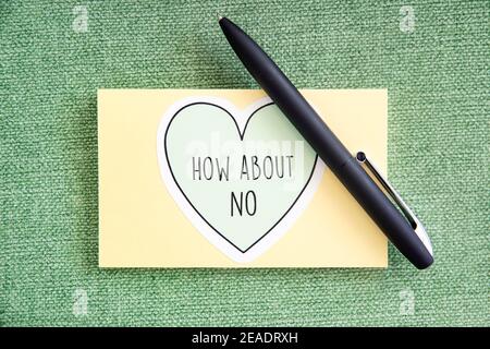 Little note to self or message written on a block of sticky notes or a small notebook that reads How about no surrounded by a doodle heart Stock Photo