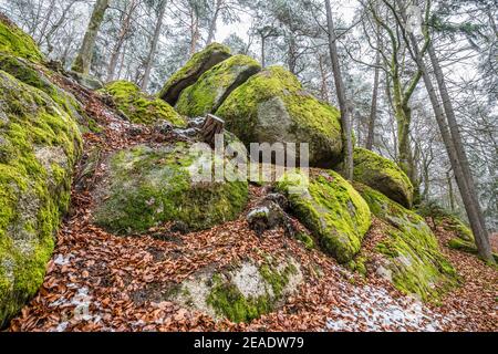 Ancient weathered megalithic granite rock formation with cave and breakthrough in Bavarian forest near Thurmansbang, Germany Stock Photo