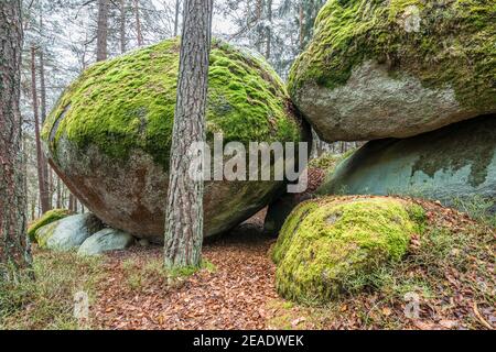 Ancient weathered megalithic granite rock formation with cave and breakthrough in Bavarian forest near Thurmansbang, Germany Stock Photo