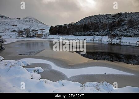 Holyrood Park, Edinburgh, Scotland, UK. 9th February 2021. Is it a bird, is it a plane?  Pictured: Dunsapie Loch with an interesting design on the surface left by the snow fall and water from the loch. Stock Photo