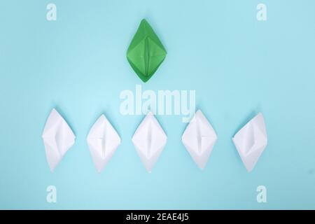 Small business, Small and Medium Enterprise concept with small Green paper ship on blue background Stock Photo