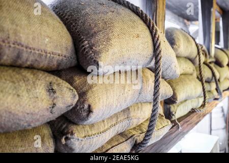 Coffee beans packed in sackcloth bags mounted with rope for transportation Stock Photo