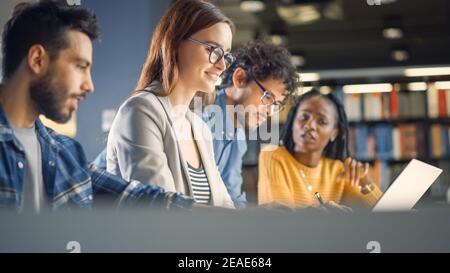 Diverse Team of Young Brilliant Internet Entrepreneurs and Office Specialists Have a Meeting, Talking, Using Laptops, Finding Solutions and Solving Stock Photo