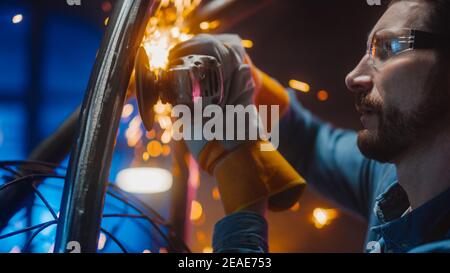 Close Up of a Talented Innovative Artist Using an Angle Grinder to Make an Abstract, Brutal and Expressive Metal Sculpture in a Workshop. Contemporary Stock Photo
