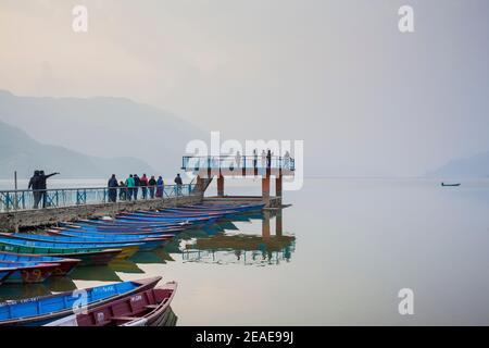 Colorful boats moored at Phewa Lake. Pokhara. Nepal. Stock Photo