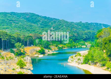 River Gardon flowing under Pont du Gard aqueduct in France Stock Photo