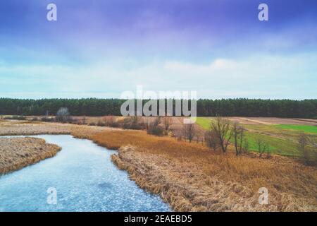 Aerial view of the countryside and frozen in autumn. Beautiful nature landscape with cloudy sky Stock Photo