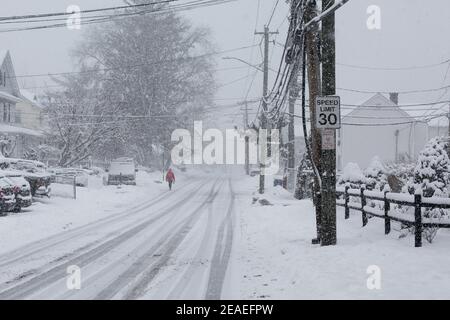 NORWALK, CT, USA -FEBRUARY 7, 2021:  Person is walking in snow storm  day on North Taylor Ave in Norwalk Stock Photo