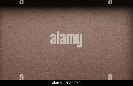 Dark brown paper background with shadow gradient macro view Stock Photo