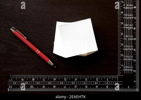 Note sticker, red pen and carpenter's square to personalize with the logo of your company over white background Stock Photo