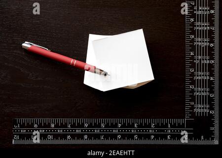 Note sticker, red pen and carpenter's square to personalize with the logo of your company over white background Stock Photo