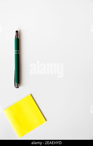 Note sticker, green pen  to personalize with the logo of your company over white background Stock Photo