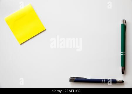 Note sticker, green pen  to personalize with the logo of your company over white background Stock Photo