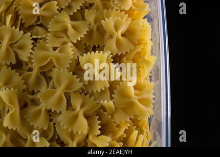 Close up of dry uncooked farfalle pasta isolated. Stock Photo