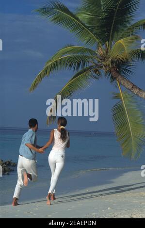 Maldives. Tropical beach. Young couple. Stock Photo