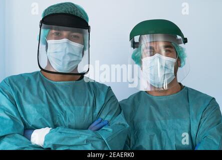 Doctors wearing personal protective equipment fighting against corona virus outbreak - Health care and medical workers concept Stock Photo