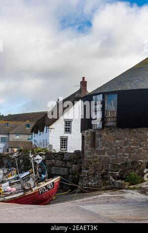 Fishing boats ashore at Sennen Cove, in front of the Round House, an 18th century capstan house, now an art gallery, Penwith Peninsula, Cornwall, UK Stock Photo