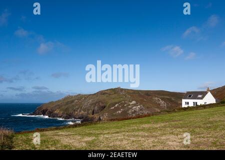 Lonely house at Porth Ledden and Kenidjack Cliff beyond: West Penwith, Cornwall, UK Stock Photo
