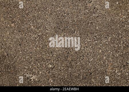 The surface of the concrete wall, the plaster consists of thousands of small, multi-colored pebbles. Stock Photo