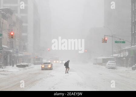 Winter blizzard in New York City with snow covered view of 3rd Avenue and 10th Street in the East Village Stock Photo