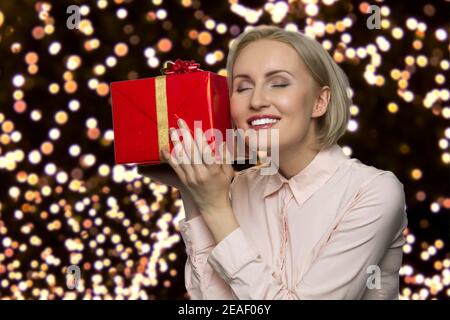 Happy middle-aged woman is enjoying her gift. Stock Photo