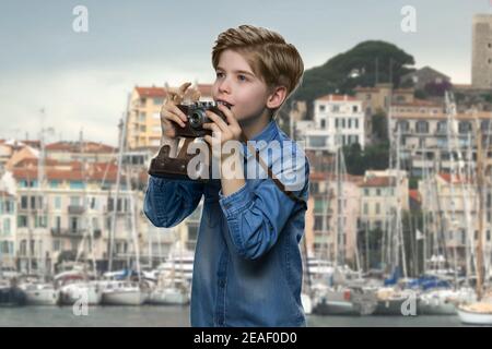 Inspired american little boy with camera. Stock Photo