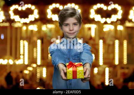 Cute little boy is giving you a present. Stock Photo