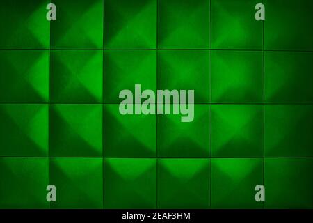 Rhombic green color wall of big squares. Unusual, beautiful and modern background. Background consists of large green squares. Stock Photo