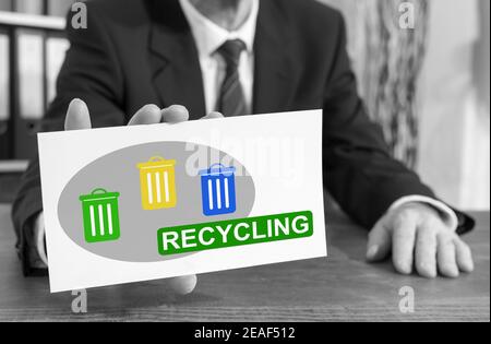Businessman showing an index card with recycling concept Stock Photo