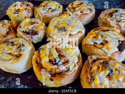 Chelsea buns with orange zest icing Stock Photo