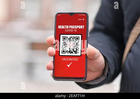 Concept for Corona virus vaccine passport on mobile phone device to allow vaccinated people privileges Stock Photo