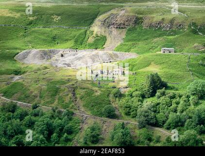 Disused lead mine buildings and spoil heaps near Gunnerside in Swaledale in the Yorkshire Dales UK Stock Photo