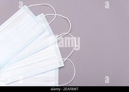 Protective medical masks on gray background, top view, medical theme Stock Photo