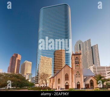 Antioch Missionary Baptist Church, 1400 Smith Street Tower (former Enron Center) behind, reflecting other downtown skyscrapers, Houston, Texas, USA Stock Photo